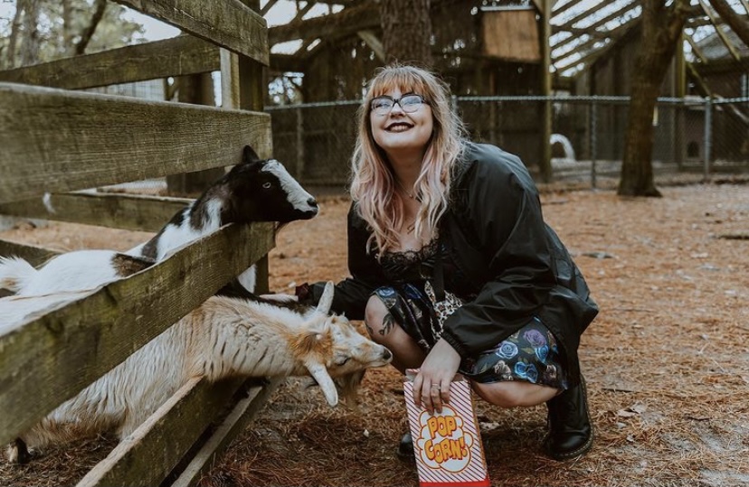 girl feeding goats popcorn strange attractions in NJ